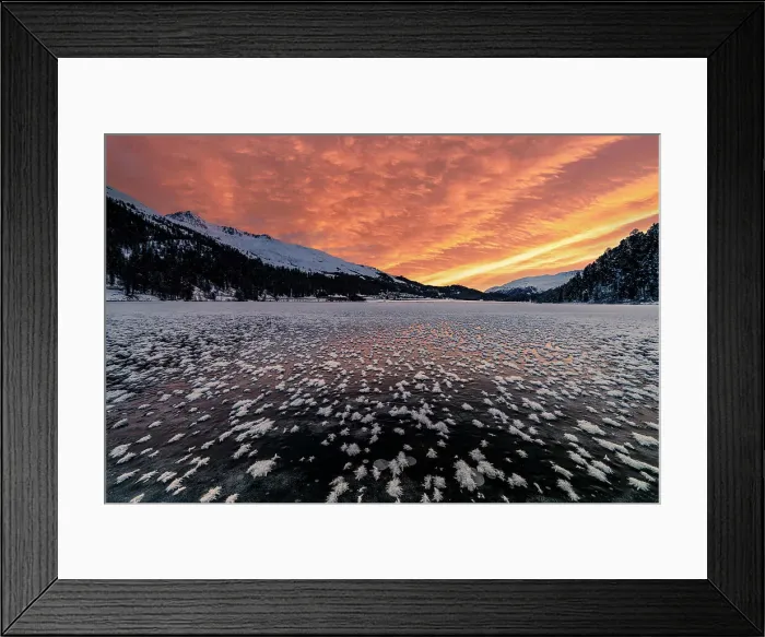 Framed Print : Burning sky at dawn over the frozen Lake Champfer covered with ice flowers in winter, Engadine, Graubunden canton, Switzerland, Europe