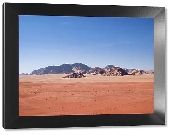 Red sand and mountains under a blue sky in the Wadi Rum desert, Jordan, Middle East
