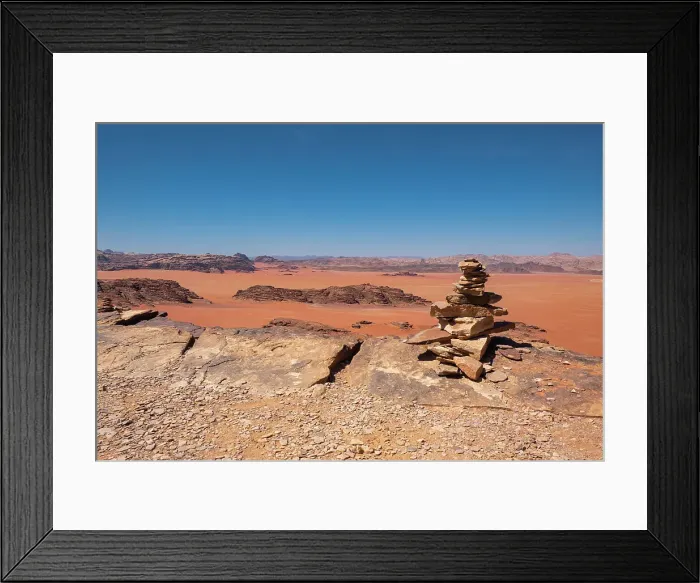 Framed Print : Wadi Rum red desert with some stone stacked in a pile in the foreground, Jordan, Middle East Framed Print : Wadi Rum red desert with some stone stacked in a pile in the foreground, Jordan, Middle East