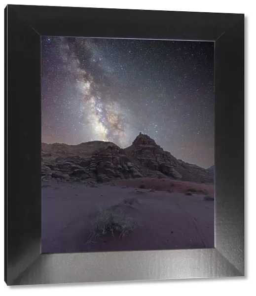 Milky Way core rising over a peak in the Wadi Rum desert, Jordan, Middle East