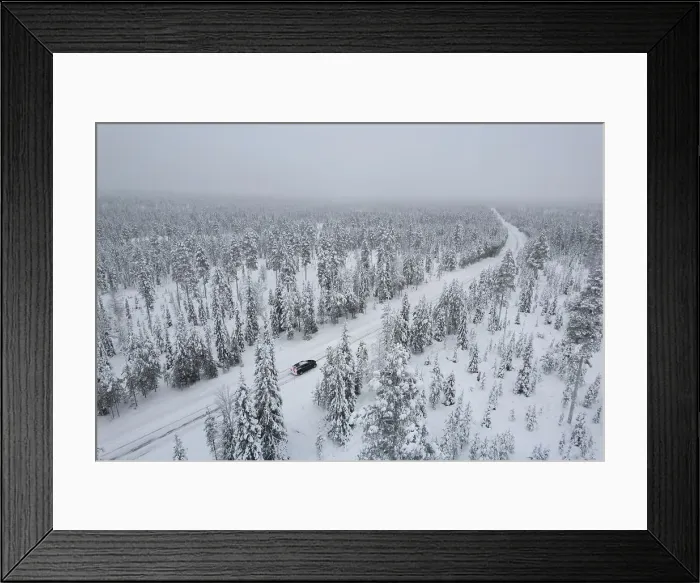 Framed Print : View from above of a car travelling icy road in the middle of the frozen forest covered with snow, Akaslompolo, Kolari, Pallas-Yllastunturi National Park, Lapland region, Finland, Europe