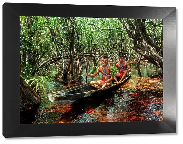 Men from the Yanomami tribe in a canoe, southern Venezuela, South America