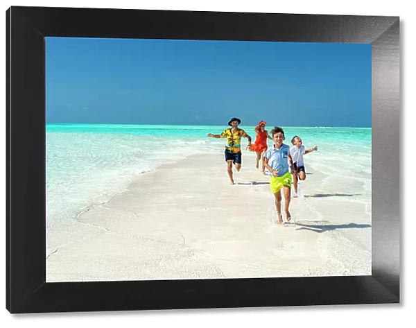 Cheerful parents with sons having fun running on an idyllic empty beach, Zanzibar, Tanzania, East Africa, Africa
