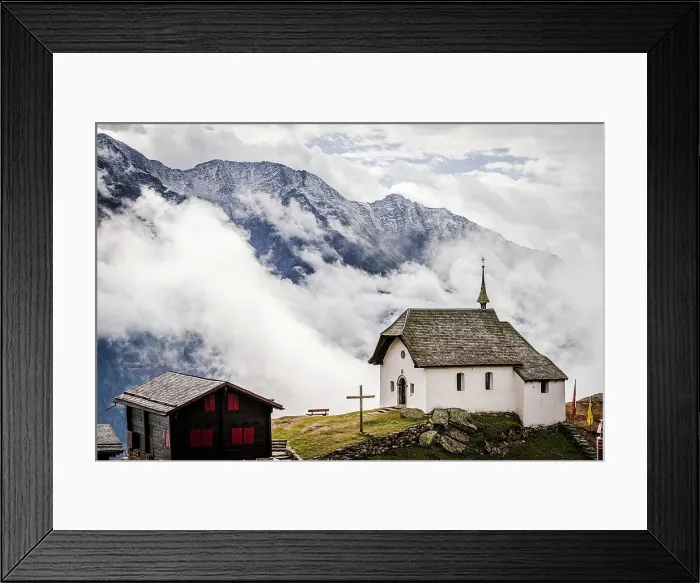 Framed Print : Foggy sky over the small church in the alpine village of Bettmeralp, canton of Valais, Switzerland, Europe Framed Print : Foggy sky over the small church in the alpine village of Bettmeralp, canton of Valais, Switzerland, Europe