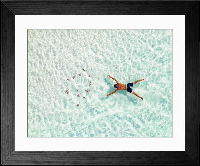 Framed Print : Aerial view of tourist admiring the colorful starfish snorkeling in the turquoise lagoon, Zanzibar, Tanzania, East Africa, Africa Framed Print : Aerial view of tourist admiring the colorful starfish snorkeling in the turquoise lagoon, Zanzibar, Tanzania, East Africa, Africa