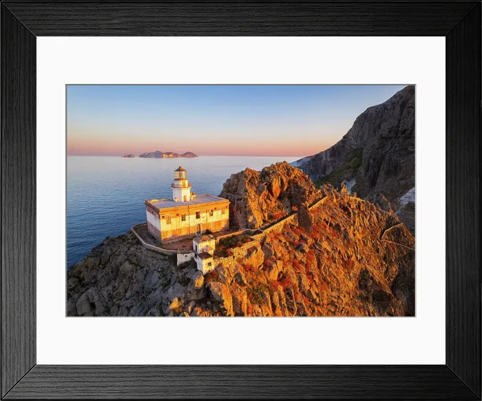Framed Print : Aerial view of Punta della Guardia lighthouse on top of a cliff on the island of Ponza, lit from sunrise, Ponza island, Pontine islands, Mediterranean Sea, Latium, Lazio, Italy, Europe Framed Print : Aerial view of Punta della Guardia lighthouse on top of a cliff on the island of Ponza, lit from sunrise, Ponza island, Pontine islands, Mediterranean Sea, Latium, Lazio, Italy, Europe