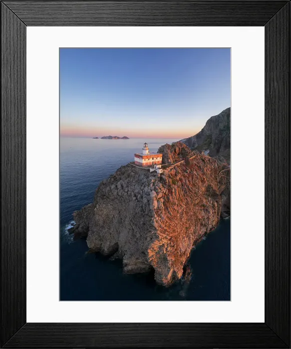 Framed Print : Panoramic aerial view of Ponza island lighthouse, Punta della Guardia, standing on top of a cliff facing the sea at dusk, Ponza island, Pontine islands, Mediterranean Sea, Latium, Lazio, Italy, Europe Framed Print : Panoramic aerial view of Ponza island lighthouse, Punta della Guardia, standing on top of a cliff facing the sea at dusk, Ponza island, Pontine islands, Mediterranean Sea, Latium, Lazio, Italy, Europe