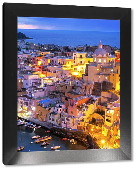 Illuminated fishing village of Marina Corricella at dusk, Procida island, Tyrrhenian Sea, Naples district, Naples Bay, Campania region, Italy, Europe