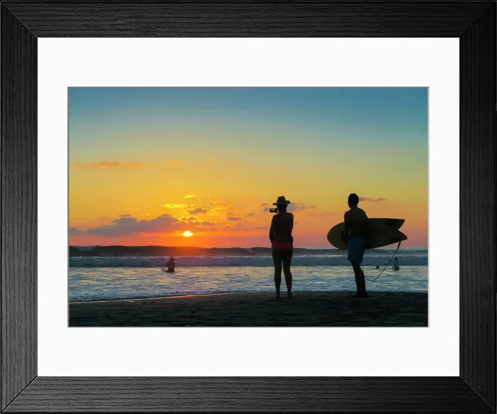 Framed Print : Surfer and woman photographing the sunset with smartphone on popular Guiones Beach, Playa Guiones, Nosara, Guanacaste, Costa Rica, Central America Framed Print : Surfer and woman photographing the sunset with smartphone on popular Guiones Beach, Playa Guiones, Nosara, Guanacaste, Costa Rica, Central America
