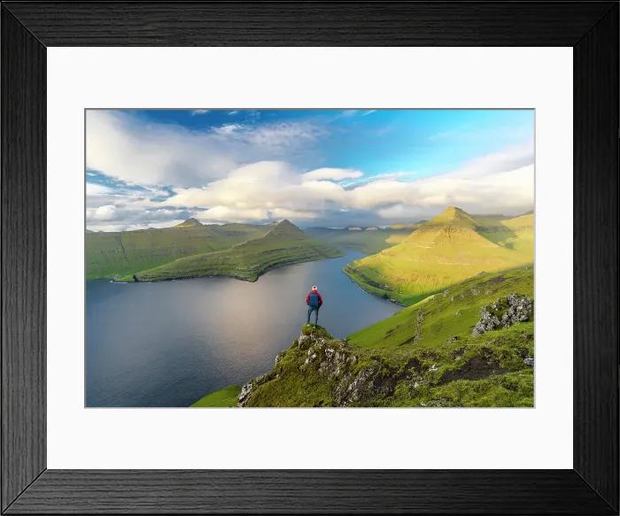 Framed Print : Hiker with backpack enjoying the view standing on rocks overlooking Funningur fjord, Eysturoy Island, Faroe Islands, Denmark, Europe Framed Print : Hiker with backpack enjoying the view standing on rocks overlooking Funningur fjord, Eysturoy Island, Faroe Islands, Denmark, Europe