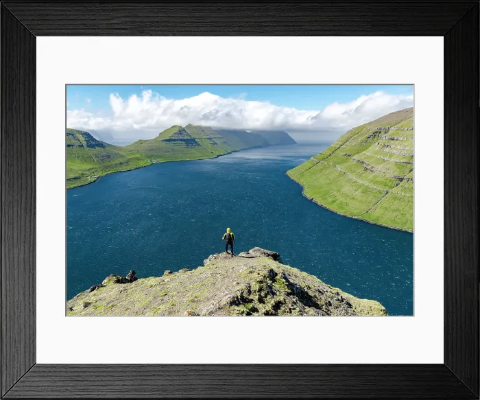 Framed Print : High angle view of hiker admiring mountains and ocean standing on top of a mountain, Klaksvik, Bordoy Island, Faroe Islands, Denmark, Europe Framed Print : High angle view of hiker admiring mountains and ocean standing on top of a mountain, Klaksvik, Bordoy Island, Faroe Islands, Denmark, Europe