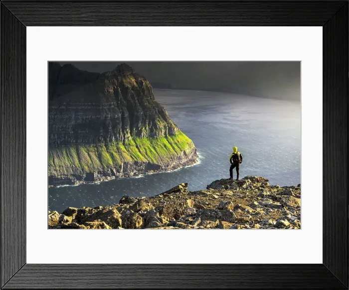 Framed Print : One man admiring the majestic cliffs along a fjord standing on top of mountain during a hike, Vidoy Island, Faroe Islands, Denmark, Europe Framed Print : One man admiring the majestic cliffs along a fjord standing on top of mountain during a hike, Vidoy Island, Faroe Islands, Denmark, Europe