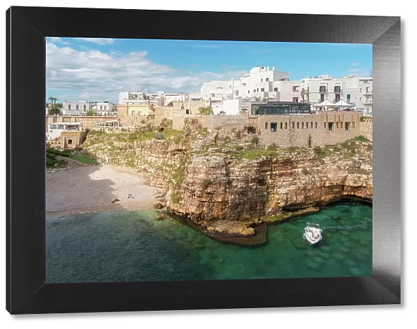 View of beach and old town on limestone cliffs, Polignano a Mare, Puglia, Italy, Europe
