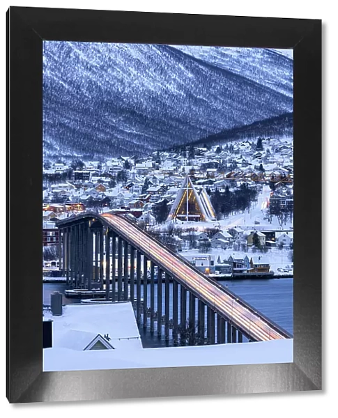 Dusk over the illuminated Bruvegen Bridge and Arctic Cathedral in winter, Tromso, Norway, Scandinavia, Europe