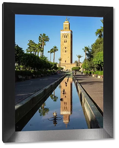 Ancient minaret tower of Koutoubia Mosque, UNESCO World Heritage Site, reflected in water in a palm fringed park, Marrakech, Morocco, North Africa, Africa