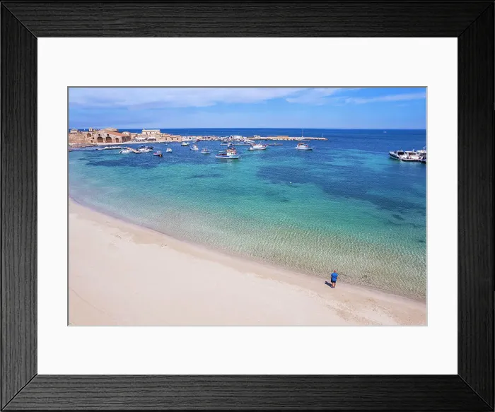 Framed Print : Aerial view of tourist standing in an empty white sand beach looking at the sea in front of the fishing village of Marzamemi, Marzamemi, Pachino municipality, Siracusa province, Sicily, Italy, Mediterranean, Europe Framed Print : Aerial view of tourist standing in an empty white sand beach looking at the sea in front of the fishing village of Marzamemi, Marzamemi, Pachino municipality, Siracusa province, Sicily, Italy, Mediterranean, Europe
