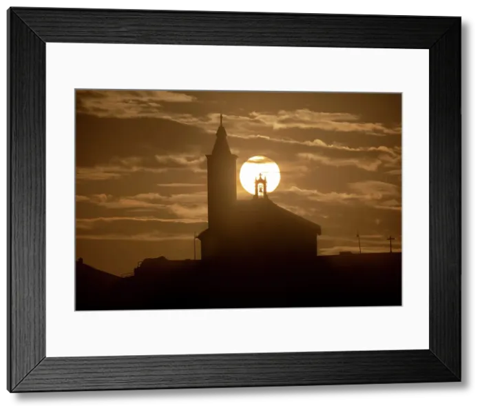 Framed Print : Sun aligned with the silhouette of the church of Luarca, Asturias, Spain, Europe Framed Print : Sun aligned with the silhouette of the church of Luarca, Asturias, Spain, Europe