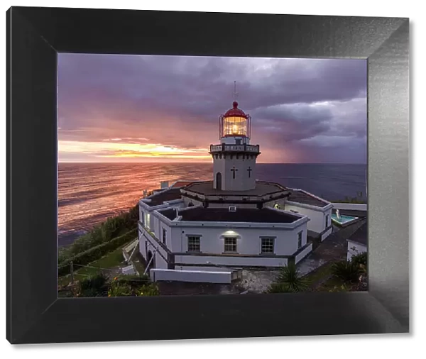 Farol do Arnel lighthouse at sunrise in a cloudy morning, Sao Miguel island, Azores, Portugal, Atlantic, Europe