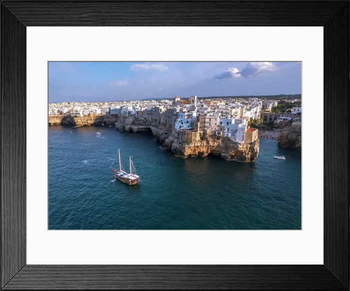 Framed Print : Sail boat anchored in the water off the white village of Polignano a Mare at sunset, Bari province, Adriatic Sea, Mediterranean Sea, Apulia, Italy, Europe Framed Print : Sail boat anchored in the water off the white village of Polignano a Mare at sunset, Bari province, Adriatic Sea, Mediterranean Sea, Apulia, Italy, Europe