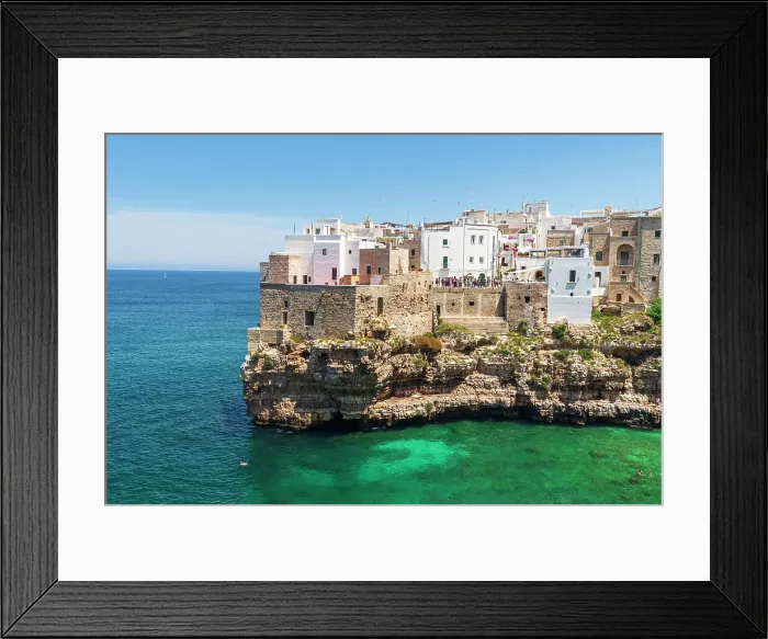 Framed Print : Polignano a mare, the medieval and white sea town facing the turquoise water of the Adriatic Sea, day time, Bari, Apulia, Mediterranean Sea, Italy, Europe Framed Print : Polignano a mare, the medieval and white sea town facing the turquoise water of the Adriatic Sea, day time, Bari, Apulia, Mediterranean Sea, Italy, Europe