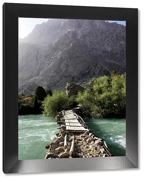 Wooden bridge over a river in the remote and spectacular Fann Mountains, part of the western Pamir-Alay, Tajikistan, Central Asia, Asia