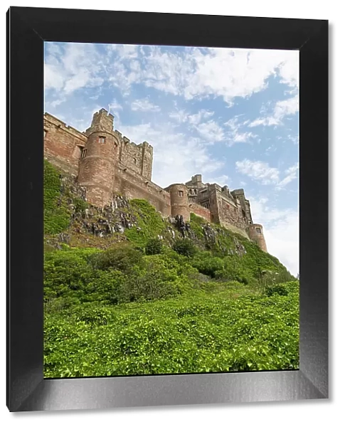 Bamburgh Castle, a hilltop fortress constructed on top of a craggy outcrop of volcanic dolerite, Grade I Listed Building, Bamburgh, Northumberland, England, United Kingdom, Europe