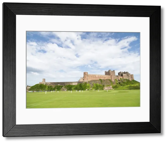 Framed Print : Bamburgh Castle, a medieval fortress, Grade I Listed Building constructed on top of a craggy outcrop of volcanic dolerite, overlooking a cricket ground, Bamburgh, Northumberland, England, United Kingdom, Europe Framed Print : Bamburgh Castle, a medieval fortress, Grade I Listed Building constructed on top of a craggy outcrop of volcanic dolerite, overlooking a cricket ground, Bamburgh, Northumberland, England, United Kingdom, Europe