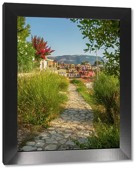 Path leading to harbour and colourful houses in Assos, Assos, Kefalonia, Ionian Islands, Greek Islands, Greece, Europe