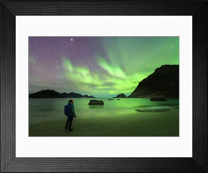 Framed Print : Man with backpack admiring the bright green lights of Aurora Borealis (Northern Lights) from Haukland beach, Lofoten Islands, Nordland, Norway, Scandinavia, Europe Framed Print : Man with backpack admiring the bright green lights of Aurora Borealis (Northern Lights) from Haukland beach, Lofoten Islands, Nordland, Norway, Scandinavia, Europe