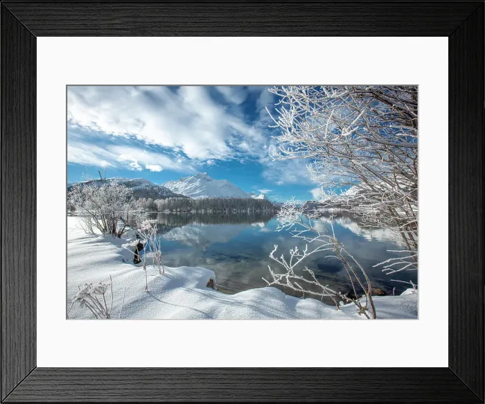 Framed Print : Clouds over snowy woods on shores of frozen Lake Sils in winter, Engadine, Canton of Graubunden, Switzerland, Europe