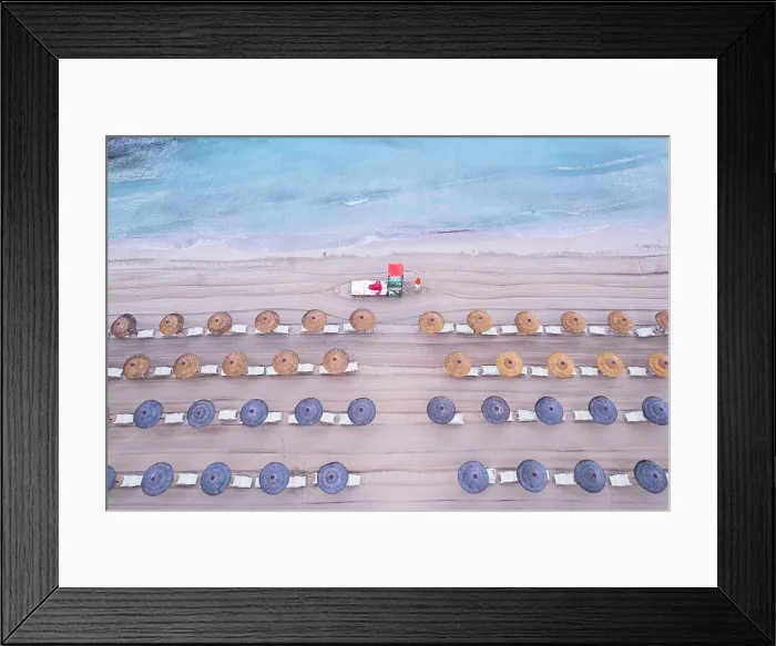 Framed Print : Aerial view of rows of beach umbrellas with a lifeguard tower on an sandy beach, Sicily island, Italy, Mediterranean Sea, Europe Framed Print : Aerial view of rows of beach umbrellas with a lifeguard tower on an sandy beach, Sicily island, Italy, Mediterranean Sea, Europe