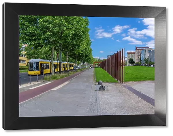 View of yellow city tram at the Berlin Wall Memorial, Memorial Park, Bernauer Strasse, Berlin, Germany, Europe