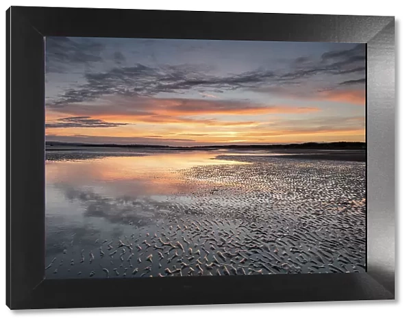 Sunset reflections on sandy beach at sunset, Camber Sands, East Sussex, England, United Kingdom, Europe