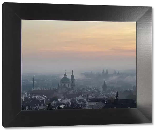 View of Prague spires and towers in morning mist from Petrin Hill, Prague, Czechia (Czech Republic), Europe