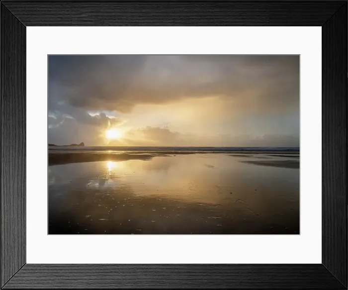 Framed Print : Rain clouds and reflections on Rhossili beach at sunset showing the shipwreck of the Helvetia, Rhossili, Gower, South Wales, United Kingdom, Europe