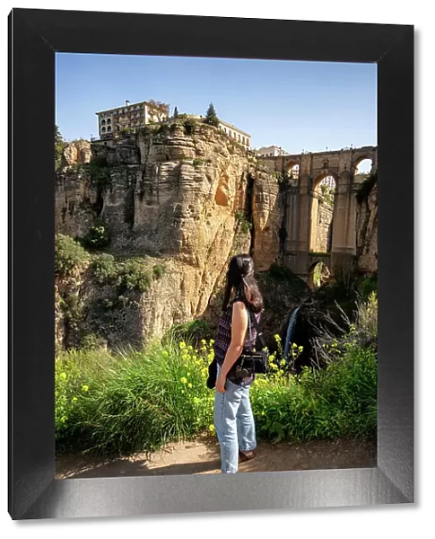 Woman looking at historic bridge of Ronda, Pueblos Blancos, Andalusia, Spain, Europe
