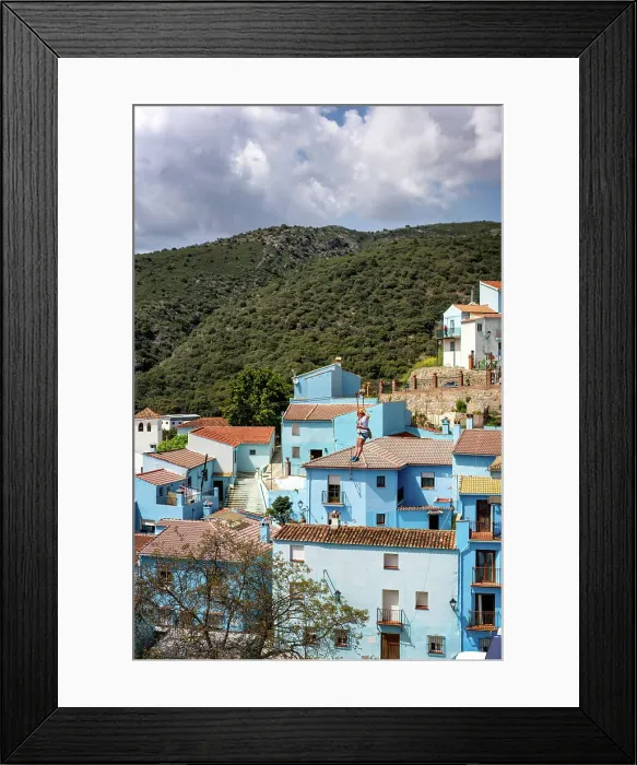 Framed Print : Person doing slide (zip line) in blue painted Smurf village of Juzcar, Pueblos Blancos region, Andalusia, Spain, Europe Framed Print : Person doing slide (zip line) in blue painted Smurf village of Juzcar, Pueblos Blancos region, Andalusia, Spain, Europe