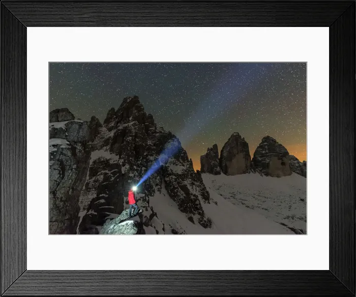 Framed Print : Man with head torch illuminates the starry sky over the snowy Paterno mountain and Tre Cime di Lavaredo (Lavaredo peaks), Sesto (Sexten), Dolomites, South Tyrol, Italy, Europe