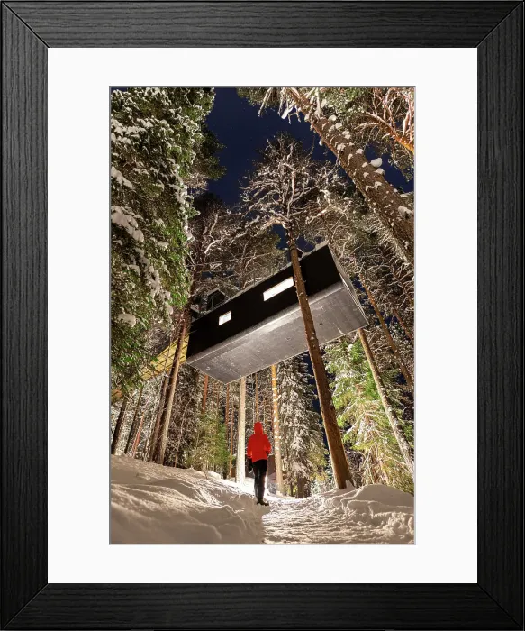 Framed Print : Tourist admires the elevated hotel room capsule shaped among snowy trees in the boreal forest, Swedish Lapland, Harads, Sweden, Scandinavia, Europe