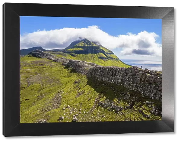 One person hikes the ridge toward the Skaelingsfjall mountain, Streymoy island, Faroe islands, Denmark, Europe