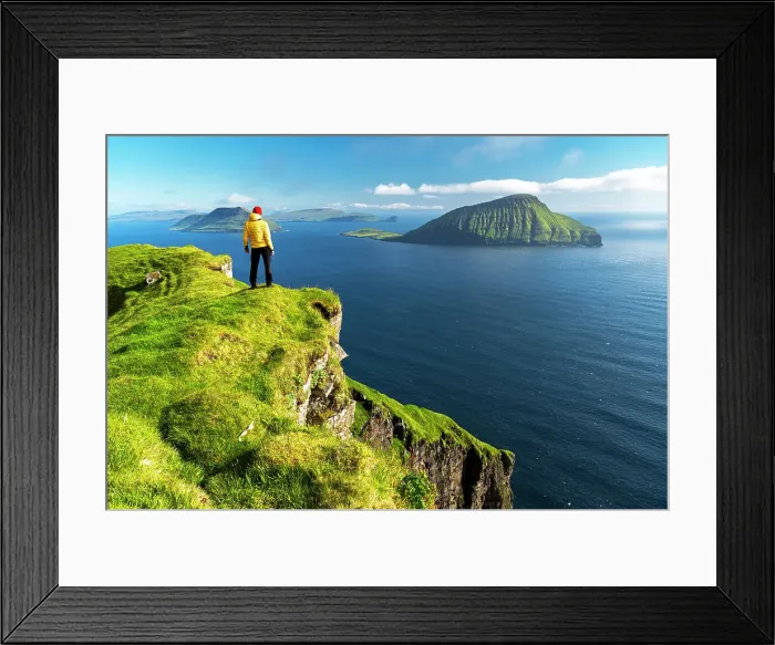 Framed Print : Hiker stands on top of a cliff admiring the rugged view, Nordradalur, Streymoy island, Faroe islands, Denmark, Europe Framed Print : Hiker stands on top of a cliff admiring the rugged view, Nordradalur, Streymoy island, Faroe islands, Denmark, Europe