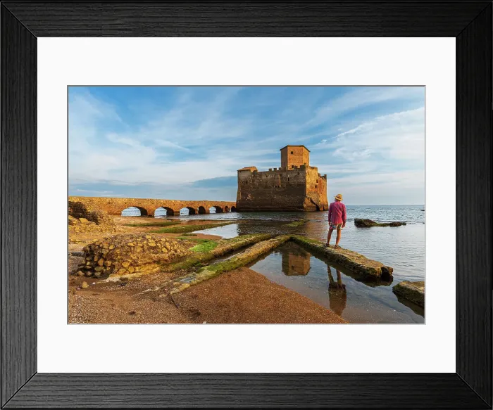 Framed Print : Man with hat stands on top of Roman ruin facing the medieval castle of Torre Astura rising from the sea, Nettuno municipality, province of Rome, Tyrrhenian sea, Latium (Lazio), Italy, Europe Framed Print : Man with hat stands on top of Roman ruin facing the medieval castle of Torre Astura rising from the sea, Nettuno municipality, province of Rome, Tyrrhenian sea, Latium (Lazio), Italy, Europe