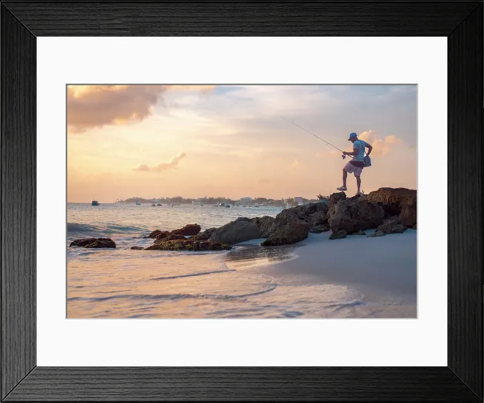 Framed Print : A local fisherman at sunset with calm water and orange sky on the south coast of Barbados, West Indies, Caribbean, Central America Framed Print : A local fisherman at sunset with calm water and orange sky on the south coast of Barbados, West Indies, Caribbean, Central America