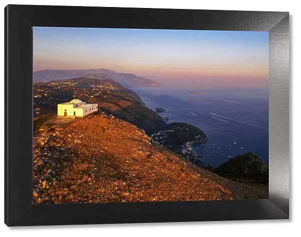 White church of San Costanzo on top of a mountain surrounding the Amalfi coast at sunset, Punta Campanella, Massa Lubrense, Naples province, Campania, Italy, Europe
