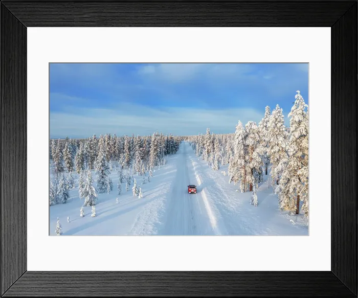 Framed Print : Drone view of a car driving on an empty and frozen road in the white landscape of Swedish Lapland, Sweden, Scandinavia, Europe Framed Print : Drone view of a car driving on an empty and frozen road in the white landscape of Swedish Lapland, Sweden, Scandinavia, Europe