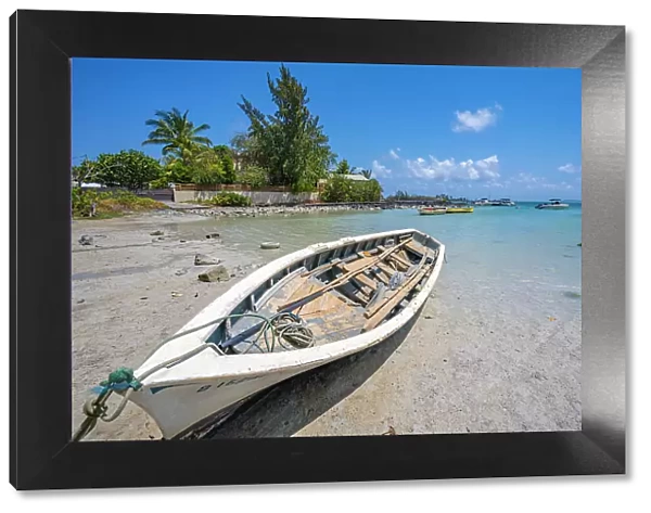 View of boat on beach and turquoise Indian Ocean on sunny day near Poste Lafayette, Mauritius, Indian Ocean, Africa