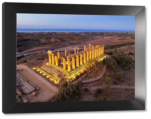 The illuminated Greek Temple of Hera seen from a drone, Valley of the Temples, UNESCO World Heritage Site, Agrigento, Sicily, Italy, Mediterranean, Europe