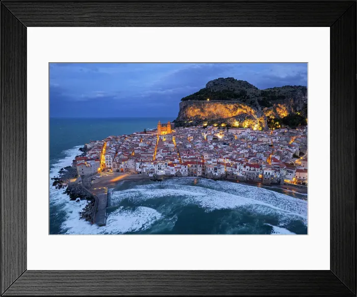 Framed Print : The illuminated fishing village of Cefalu with the rock on top of the old town seen from the drone at dusk, Cefalu, Palermo province, Tyrrhenian Sea, Sicily, Italy, Mediterranean, Europe