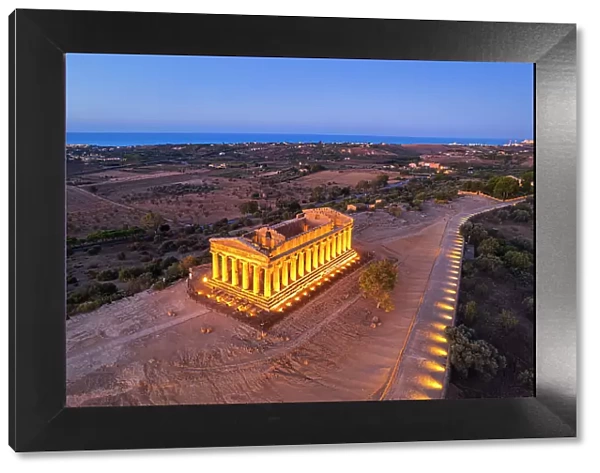The illuminated Temple of Concordia seen from a drone at dawn, Valley of the Temples, UNESCO World Heritage Site, Agrigento, Sicily, Italy, Mediterranean, Europe