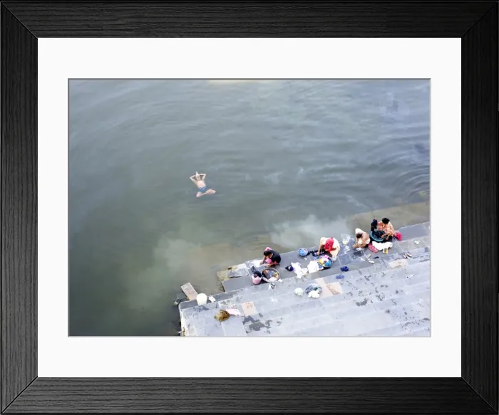 Framed Print : Man doing early morning yoga excercises in the water near the dhobi (washing) ghats Framed Print : Man doing early morning yoga excercises in the water near the dhobi (washing) ghats